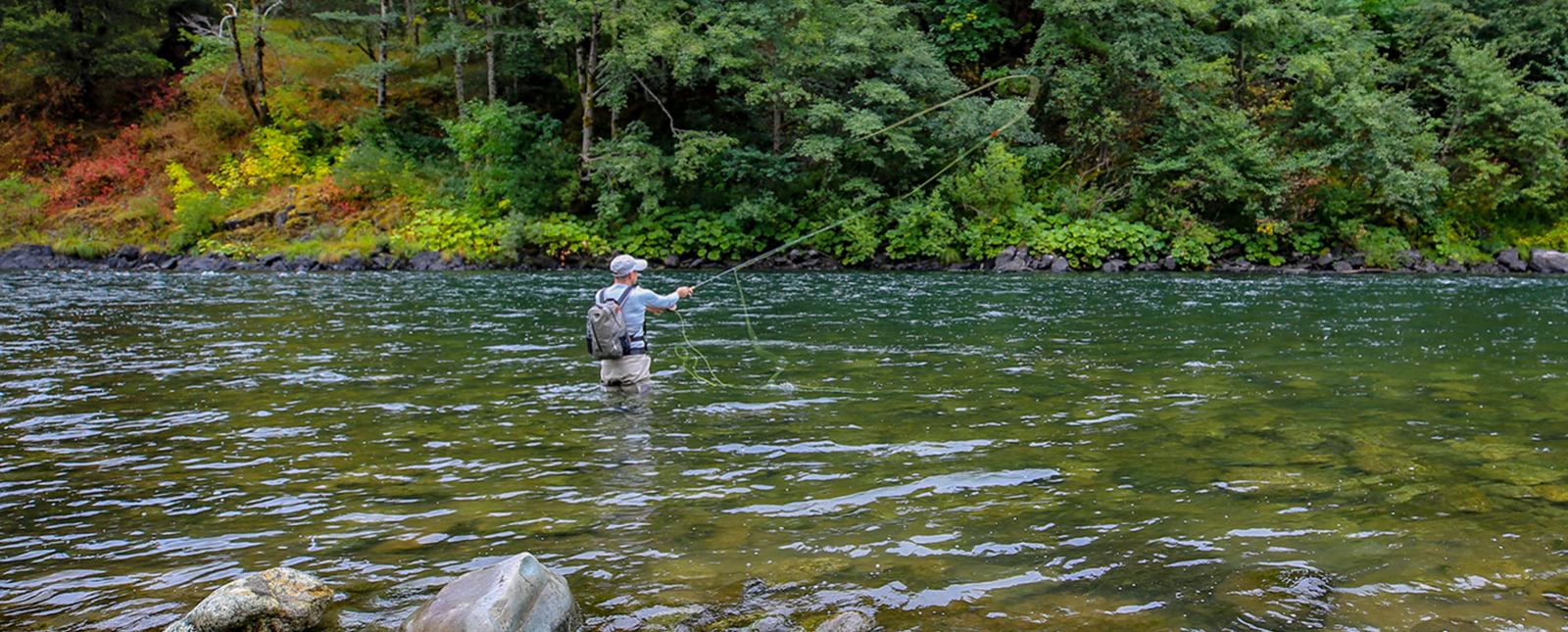 Fly fishing along Connecticut riverside