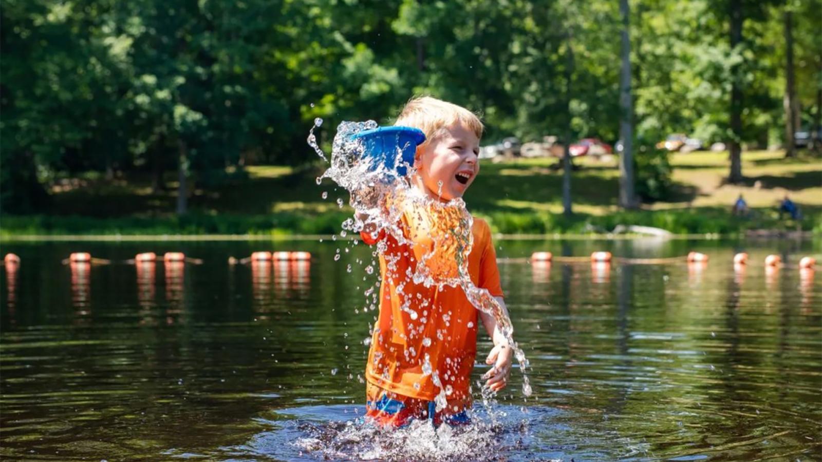 A boy splashing playfully in the water (Instagram@rachela.higgins)