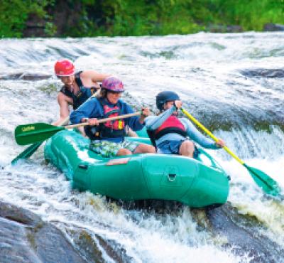 Team of white water rafters going down Housatonic River 