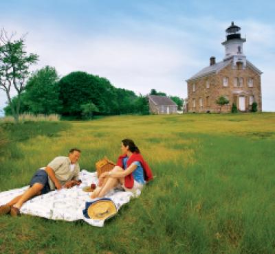 Couple picnicking in front of lighthouse at Sheffield Island