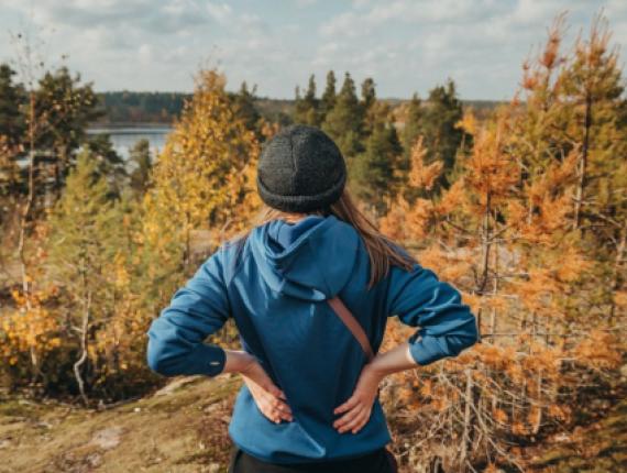 A woman on a hike pausing to look at fall scenery (Instagram@baymontinngroton)