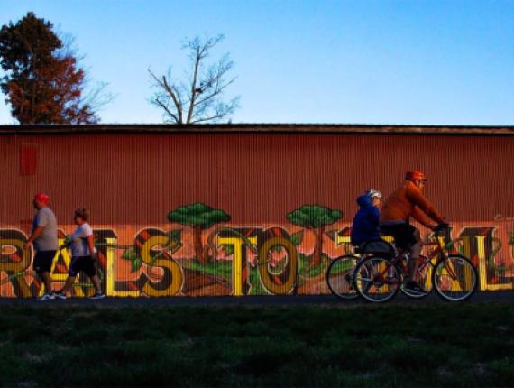 People walking and biking in front of mural (Instagram@aflaum)