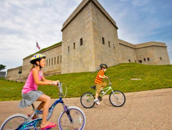 Kids bike riding outside path of Fort Trumbull State Park
