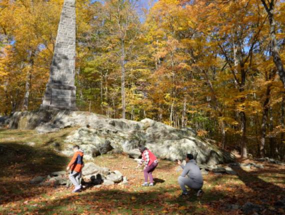 Family exploring monument at Putnam Memorial State Park 
