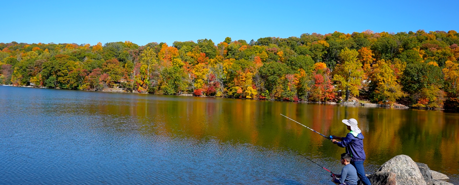 Father and son fishing along Squantz Pond in New Fairfield