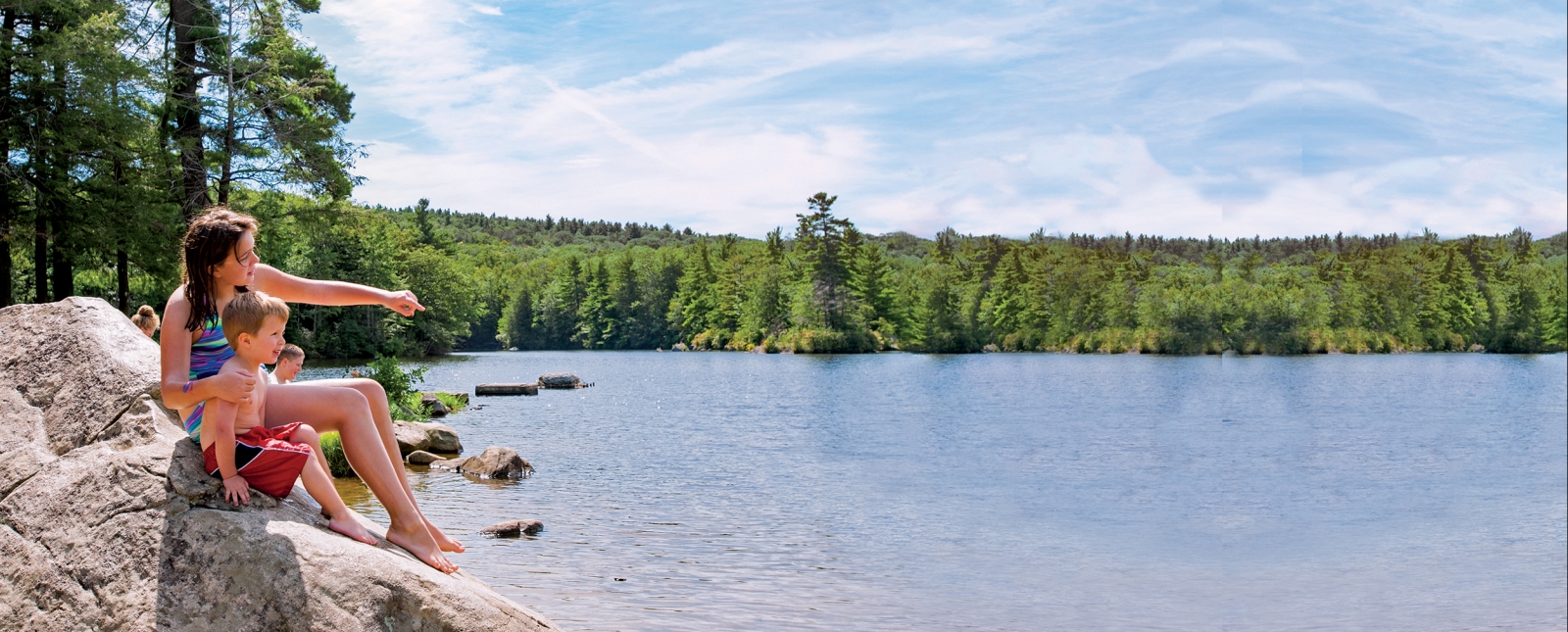 Two kids on rocks overlooking Burr Pond