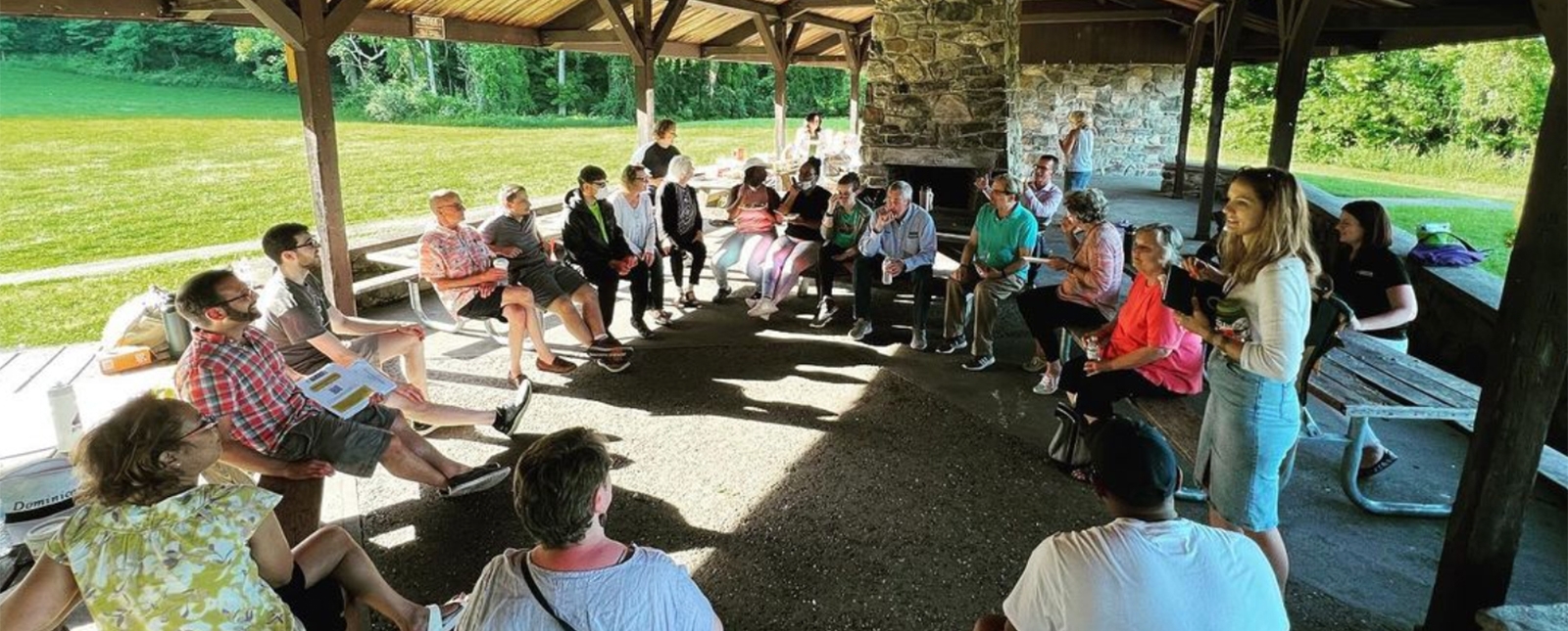 A group of people under a shelter at the park