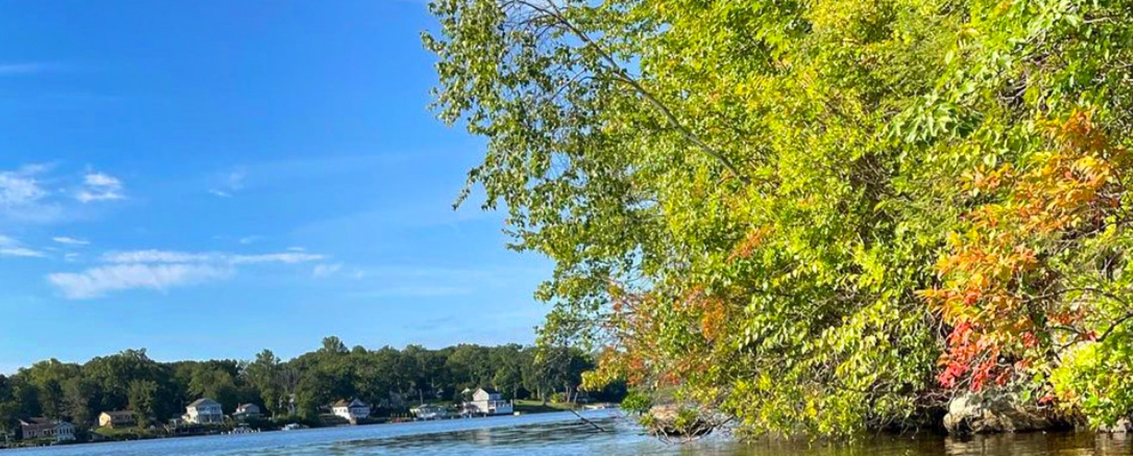 A scenic view of the water and a beautiful blue sky.