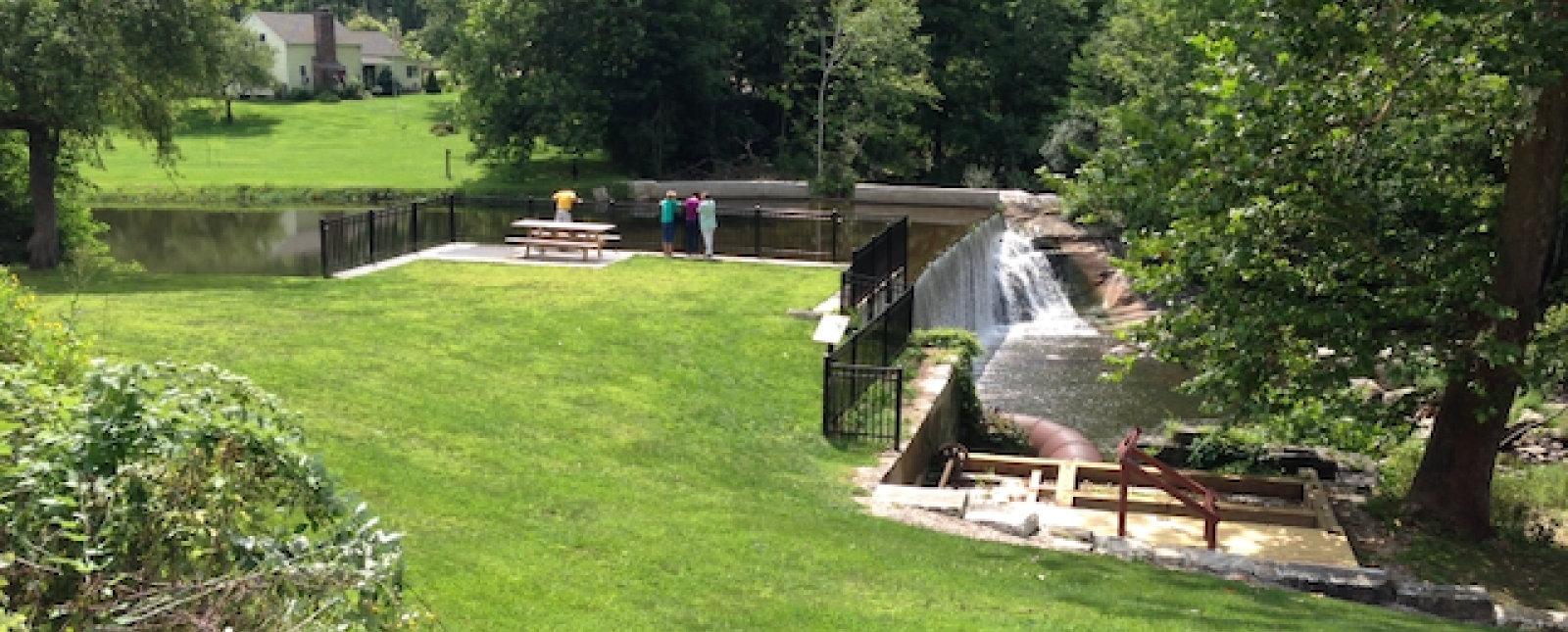 Overlooking green grassy area and waterfall at Beckley Furnace