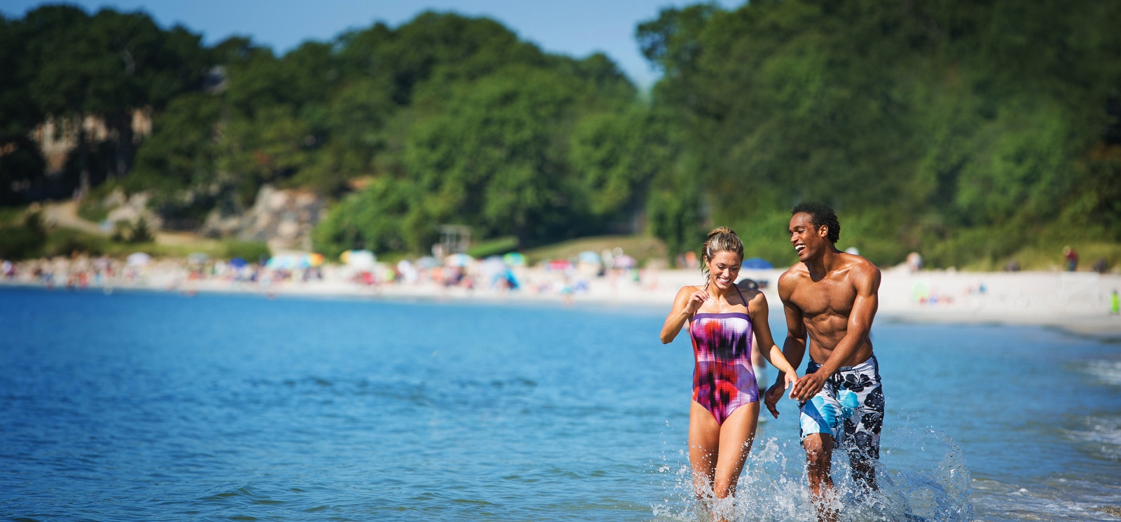 Couple running along shoreline at Rocky Neck State Park