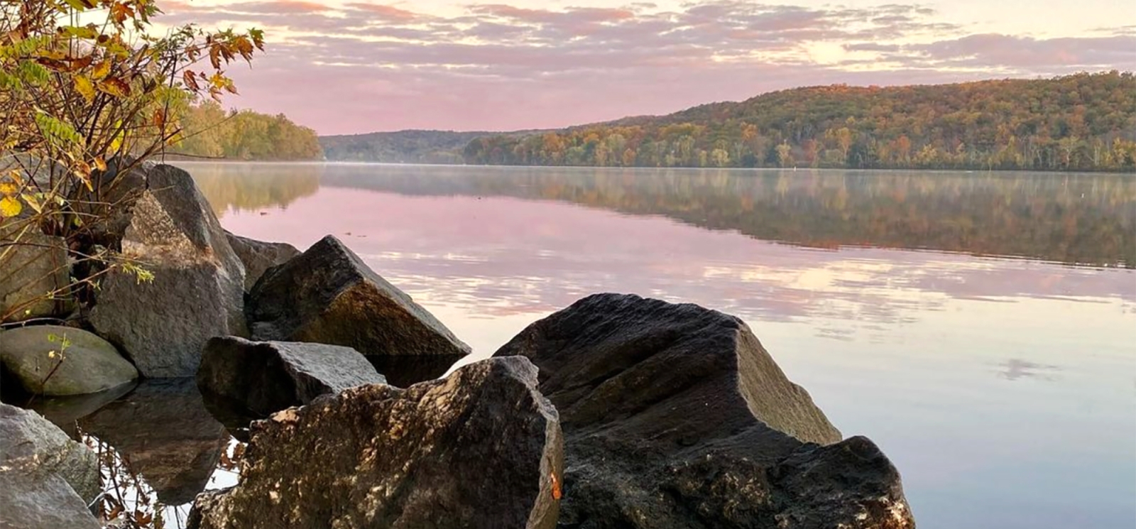 Rocks and water with lake and trees in background (Instagram@the_real_nature_renee)