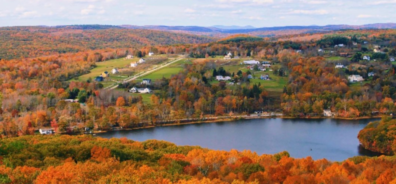 view of rolling hills of autum trees and town in the distance (Instagram@queenvictoria.bea_)