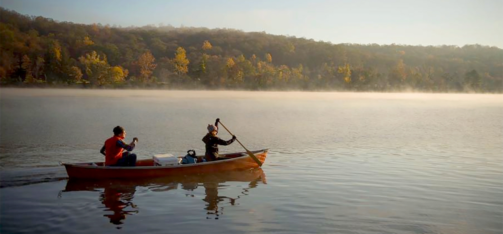 Two people canoeing on a misty lake (Instagram@hot_baked_stoke_)