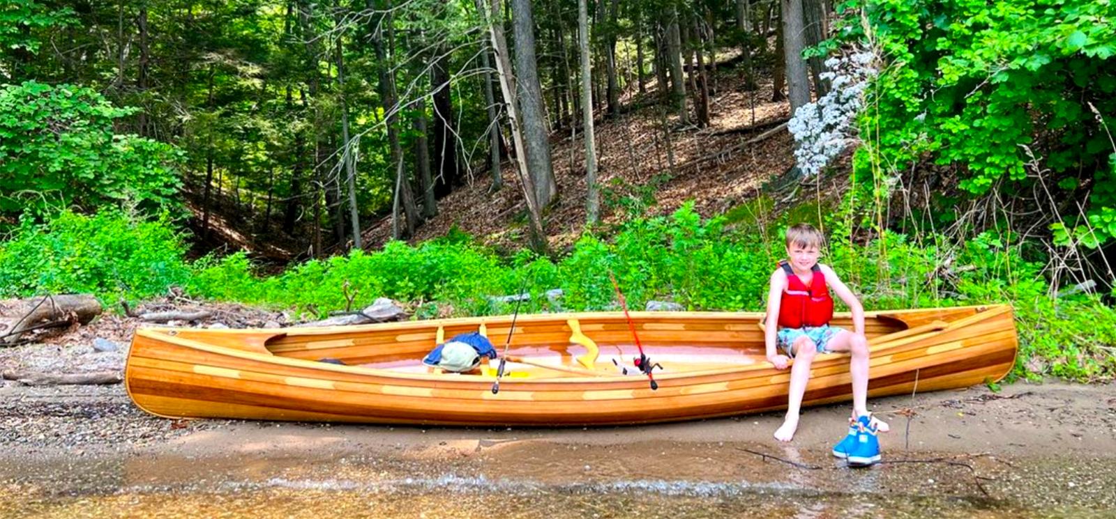 Boy in a canoe with fishing poles (Instagram@seankeenan)