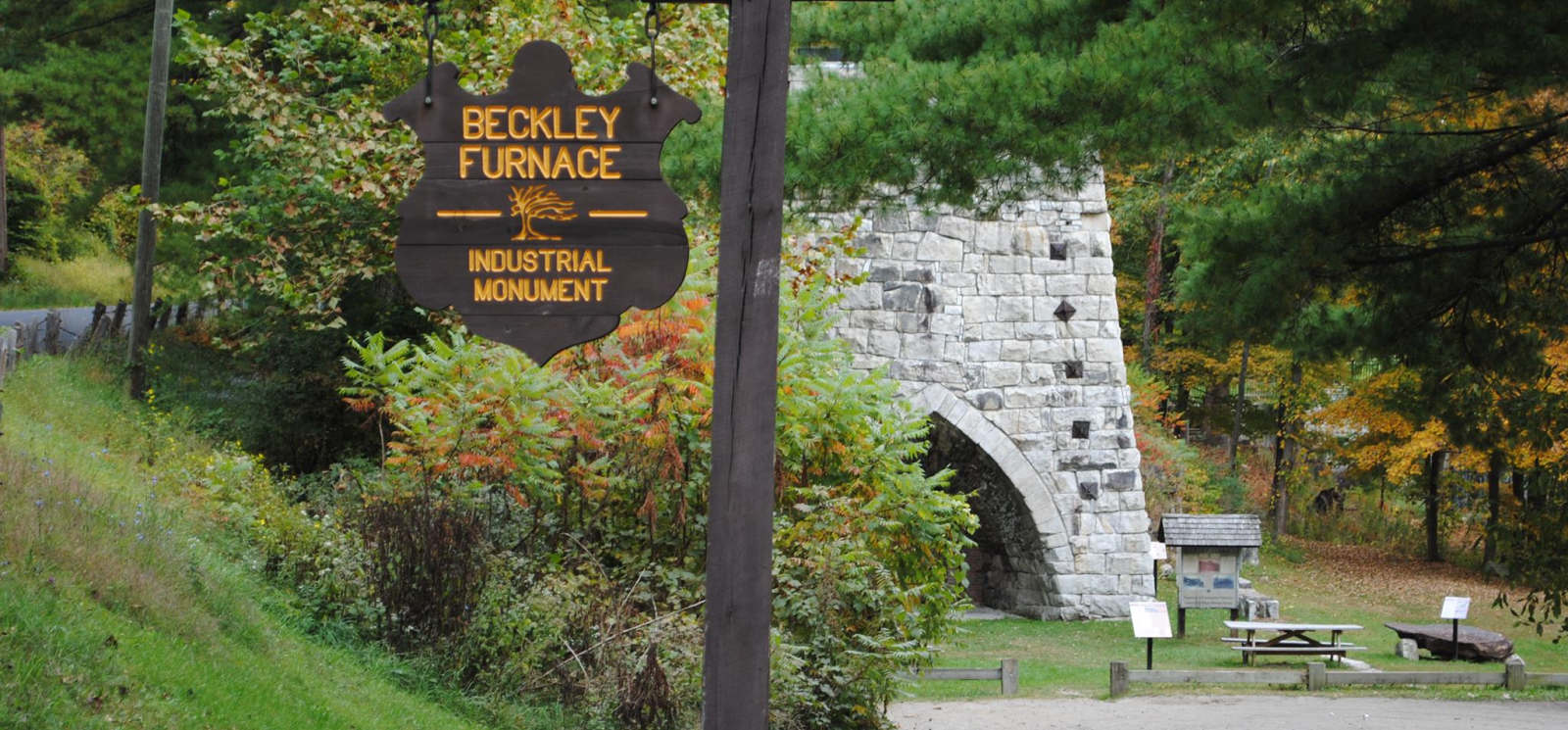 The industrial monument stone furnace with Beckley Furnace Industrial Monument sign in foreground