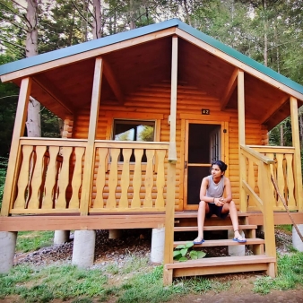 Woman sitting on cabin in Black Rock campground (Instagram@stephy.d.silva)