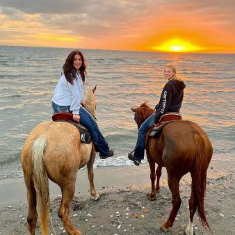 Two women horseback riding along shoreline at Hammonnassett Beach (Instagram@_allylund_)