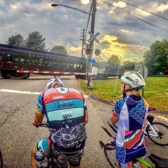 Two bicyclists watching a passing train (Instagram@ky_ky_mcfly)