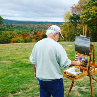 A man painting a fall scene (Instagram@b.allen413)