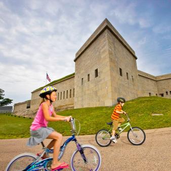 Kids bike riding outside path of Fort Trumbull State Park