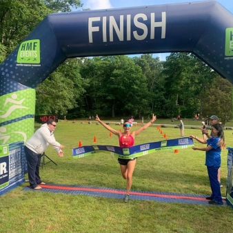 Woman running a race to the finish line (Instagram@soundrunner_racing)