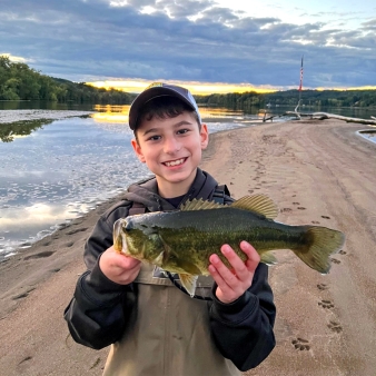 A boy holding a fish he caught on the beach (Instagram@rosafamoutdoors)