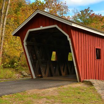Covered bridge entrance of Kent Falls in Fall