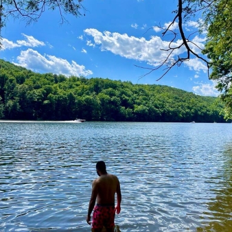 People swimming in the lake as boats pass in the distance (Instagram@akrokhalid)