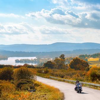 Leisure motorcycle ride with scenic Lake Waramaug in background