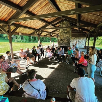 A group of people under a shelter at the park