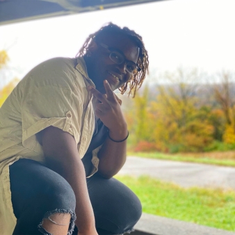 A person posing on a picnic table (Instagram@its_benji_bish)