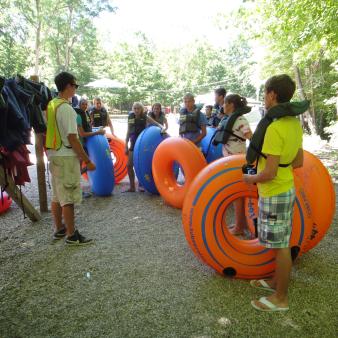 People standing with tubes ready to go tubing (CTVisit)