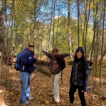 Three women on a hike through the woods (Instagram@jeteallard)