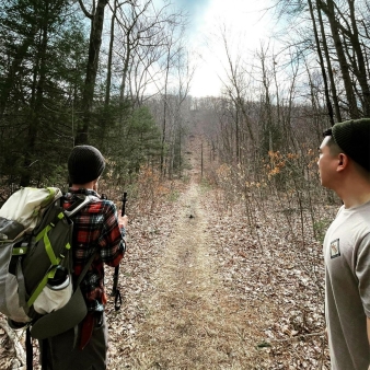 Two men hiking on a path through the woods (Instagram@jeep_new_england)