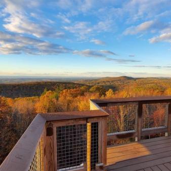 A balcony overlooking beautiful fall foliage and sky (Instagram@lanky_lanyards)