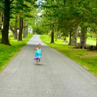 Young girl running down path at Topsmead
