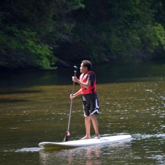 Young man on stand-up paddleboard at Hopeville Park (Instagram@CTstateParks)