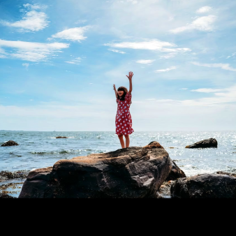 Young girl standing on rocks at Bluff Point State Park (Instagram@krishna-roegiers)