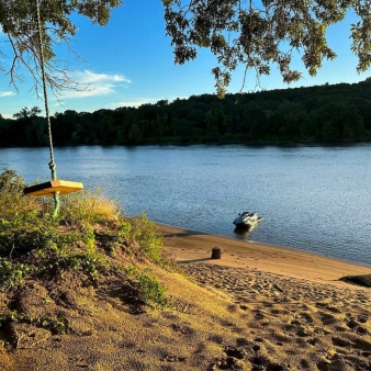 A jet ski resting on the sandy shore.