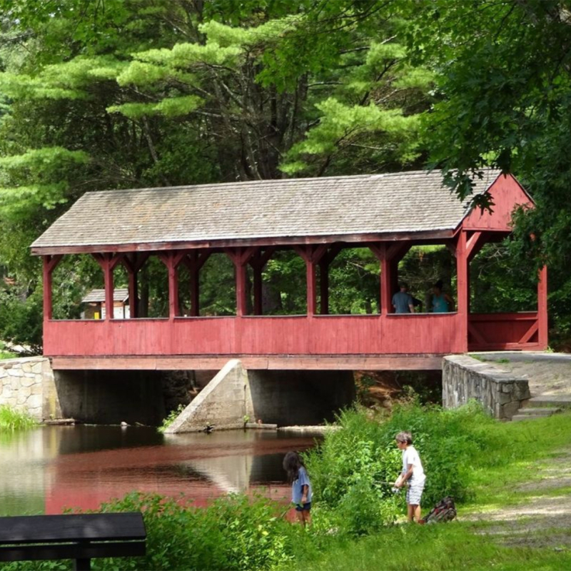 Kids fishing at Stratton Brook with covered bridge in background (Instagram@visitnewengland)