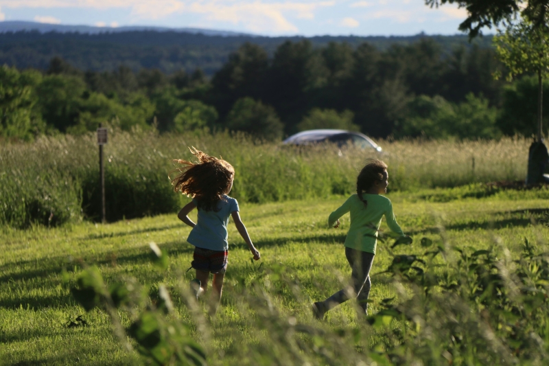 Two children running in a field