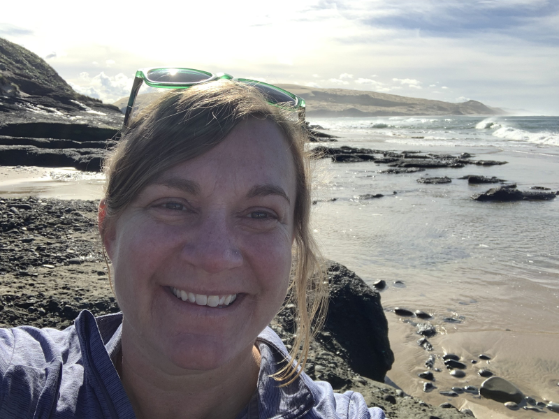 Dr. Beth Lawrence with a shoreline view behind her