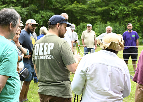 Demonstration of setting up an electric fence to deter wildlife.