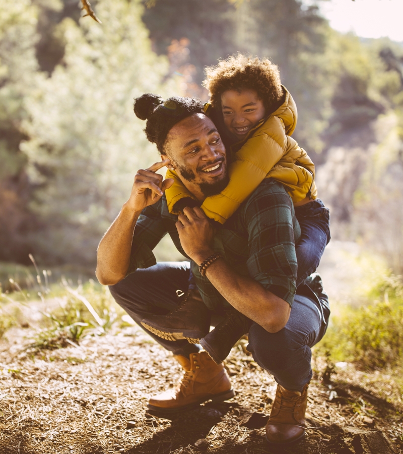 Father and son hiking in woods