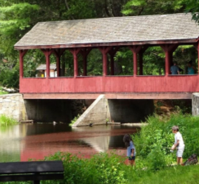 Kids fishing at Stratton Brook with covered bridge in background (Instagram@visitnewengland)