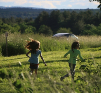 Two children running in a field