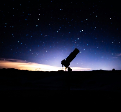 Silhouette of a telescope on the horizon just after sunset