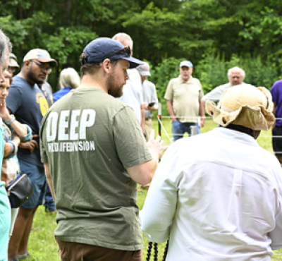 Demonstration of setting up an electric fence to deter wildlife.