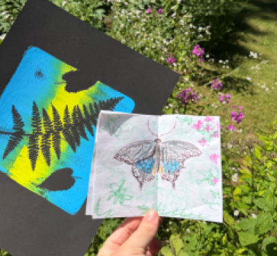 Print of a fern and drawing of a black butterfly in front of garden flowers