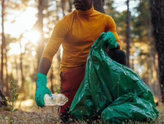 Man picking up litter in CT state forest